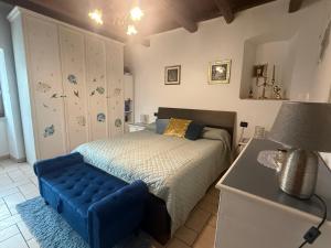 ein Schlafzimmer mit einem Bett und einer blauen Bank darin in der Unterkunft Mameli 27 in Spoleto