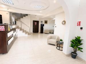 a lobby with a staircase and a waiting room at Casa Mario in Eforie Nord