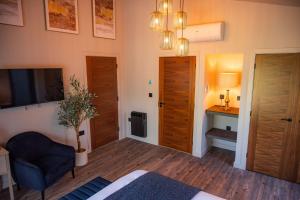 a room with a bed and a chair and a desk at Retreat 1 in Beccles +9 photos