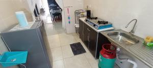 a small kitchen with a sink and a stove at Homestay Cikgu 2 Hospital Kuala Krai in Kuala Kerai +10 photos
