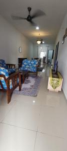 a living room with several beds and a couch at Homestay Cikgu 2 Hospital Kuala Krai in Kuala Kerai