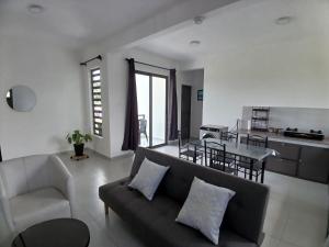 a living room with a couch and a table at Acacia Residences in Post of Flacq