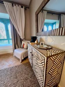 a bedroom with a mirror and a bed in a room at Serene Villa with 4 Pools, Palmeraie, Marrakech in Douar Soukkane +62 photos