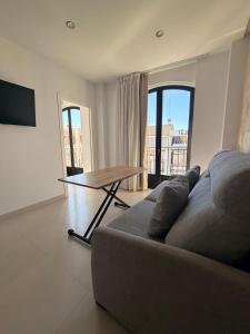 a living room with a couch and a table at Quercus in Pozoblanco