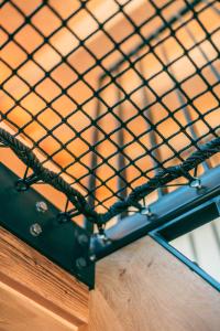 a black metal cage on top of a wooden table at Nînda Boutique Hôtel in Nendaz
