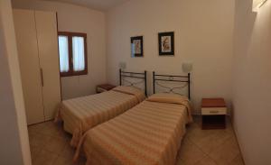 a bedroom with two beds and a window at Residence Villa Candida in Vieste
