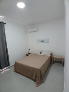 a bedroom with a bed in a white room at Acacia Residences in Post of Flacq