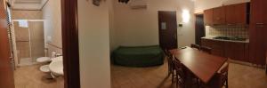 a kitchen with a table and a bathroom with a toilet at Residence Villa Candida in Vieste +26 photos