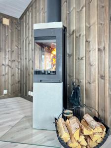 a toaster oven with a basket of bread in front of it at High-standard cabin with jacuzzi & stunning views in Øyer +36 photos