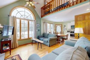 a living room with a blue couch and a table at 205 Town Hall Road in Lower Bartlett