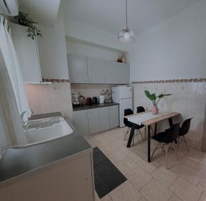 a kitchen with a table and chairs and a sink at Selini Apartments Mani in Agios Nikolaos +38 photos