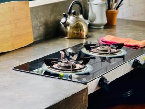 a stove top with two cakes on top of it at REZ SPACE Apartment 01 in Hiriketiya
