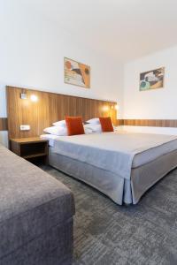a hotel room with two beds in a room at Art Hotel superior in Zalakaros