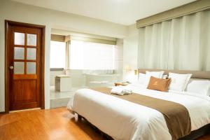 a large bedroom with a large bed and a bathroom at Gran Hotel Continental in Cajamarca +21 photos