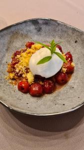 a plate of food with a dessert on a table at La Fompatoise in Vérines