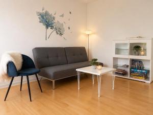 a living room with a couch and a table at Stor 2 værelses lejlighed in Randers