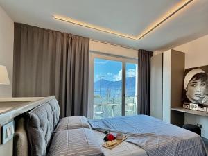 a bedroom with a bed with two stuffed animals on it at Lakeview in Luino