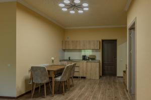 a kitchen with a table and chairs in a room at Old House Residence Aghveran & Restaurant in Arzakan +7 photos