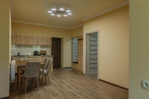 a kitchen and dining room with a table and chairs at Old House Residence Aghveran & Restaurant in Arzakan