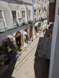 an overhead view of an alley with buildings and people at Zanzibar stone town house in Zanzibar City