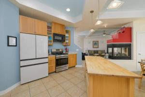 a large kitchen with white appliances and a wooden island at 216 New Castle St, Rehoboth Beach in Rehoboth Beach