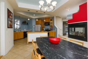 a kitchen and dining room with a table with a red bowl at 216 New Castle St, Rehoboth Beach in Rehoboth Beach