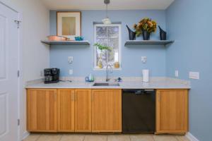 a kitchen with wooden cabinets and a sink at 216 New Castle St, Rehoboth Beach in Rehoboth Beach