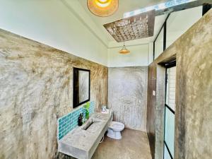a bathroom with a sink and a toilet at REZ SPACE Apartment 03 in Dickwella