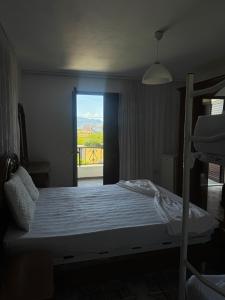 a bedroom with a bed with a view of a balcony at Villa Velipoj in Velipojë