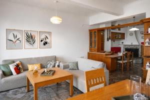 a living room with a couch and a table at Matroni's House - Seafront Getaway in Monemvasia in Monemvasia +26 photos