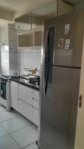 a kitchen with a stainless steel refrigerator in it at AP da Vicky 2 quartos central São Luis in São Luís