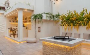 a room with a table and some plants at Salt & Palm Villa in Maggona West
