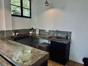 a kitchen with a sink and a counter top at REZ SPACE Apartment 05 in Hiriketiya