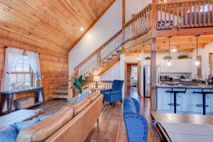 a living room with a large couch and a staircase at Beaver Rock Lodge in Elk Park