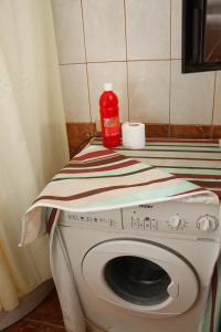 a washing machine with a towel on top of it at La Famiglia Villa in Velipojë