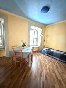 a room with a table and chairs and a bed at Diaz 10 Suite in Trieste