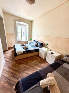 a bedroom with two beds and a window at Diaz 10 Suite in Trieste