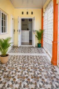 a hallway of a house with a tiled floor at Hotel National Ambanja in Ambanja