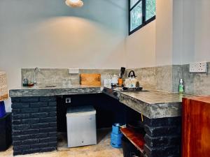 a kitchen with a stone counter and a sink at REZ SPACE Apartment 06 in Hiriketiya +6 photos