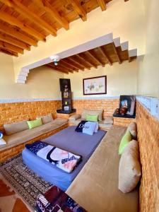 a living room with a large couch at Grotte pied dans l'eau in Aglou