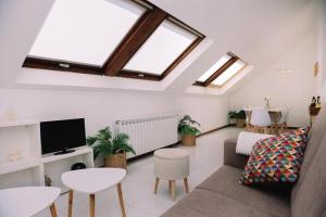 a living room with a couch and a tv at Casa Meiramar in Moaña