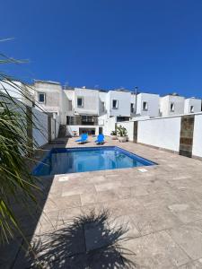 a swimming pool in front of a house at Chalet Adosado en Playa La Barrosa in Novo Sancti Petri