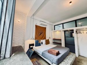 a bedroom with a bed and a large window at REZ SPACE Apartment 06 in Hiriketiya