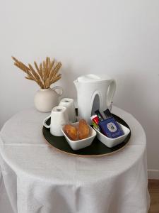 a table with a plate with food and a coffee maker at Les Jujubiers in Draguignan