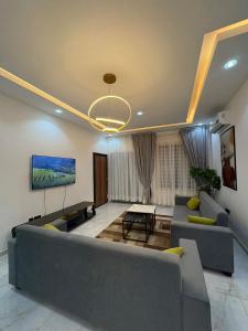 a living room with a couch and a tv at Stay-City Oliver in Apenkwa +30 photos