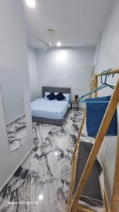 a room with a bed and a staircase in it at homestay chendorini cherating in Kampong Chendar