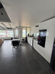 a large kitchen with a table and a dining room at JPY S Suite in Pointe-à-Pitre