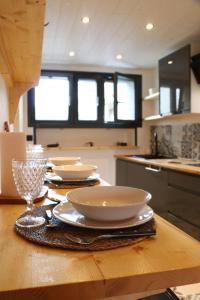 a wooden table with plates and bowls on top of it at Près de l'aéroport in Ossun