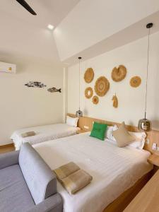 a bedroom with two beds and a couch at Aonang nine poolvilla resort in Ao Nang  +92 photos