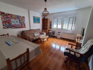 a living room with a table and a couch at Las 4 columnas (MFA) in Muxia